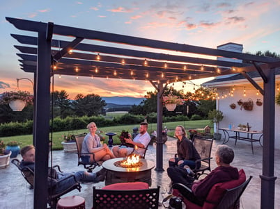 a-family-relaxing-around-a-fire-table-in-outdoor-s-2021-09-04-09-55-06-utc